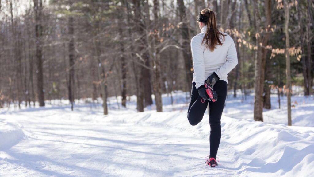 Standing quadriceps stretch is a basic mobility stretch you can do anywhere, even on a snow covered forest trail.