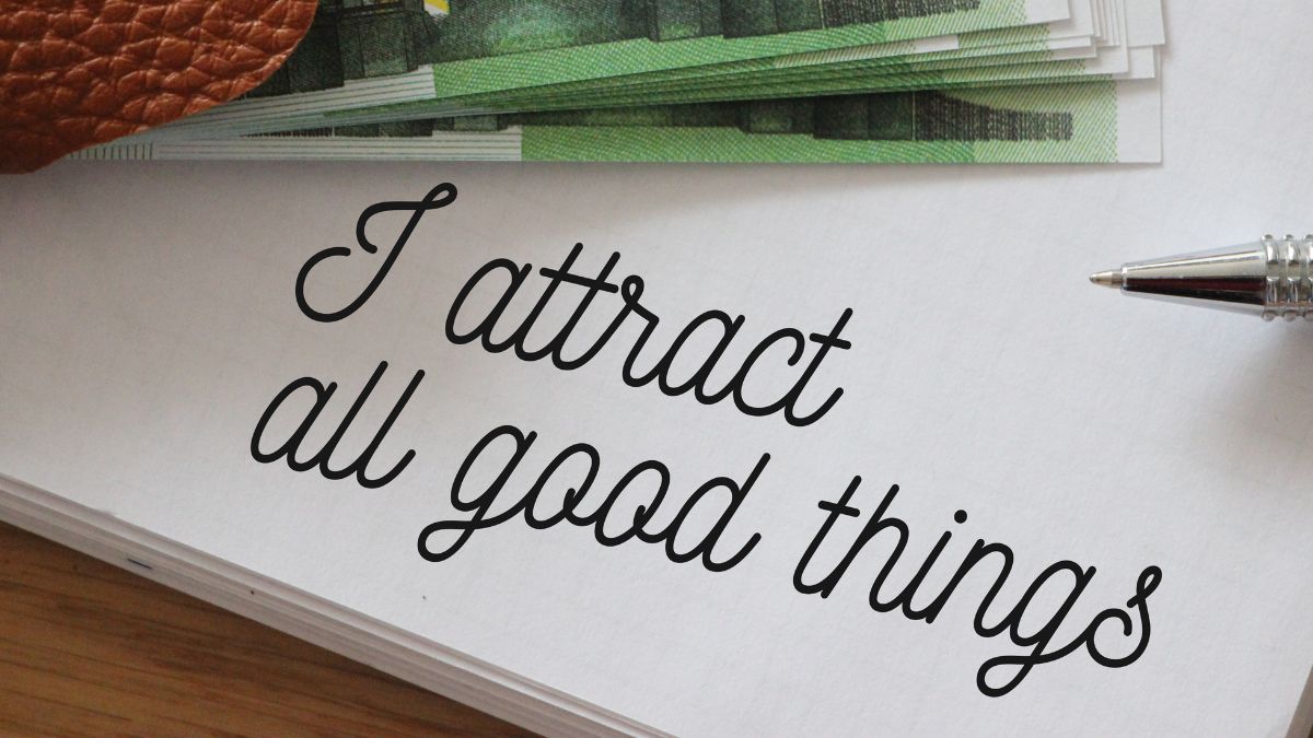 12 Laws of Attraction positive affirmation "I attract all good things" written on paper.